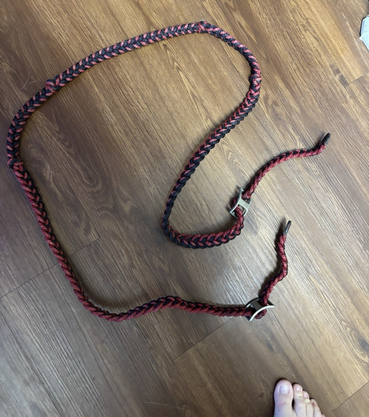 Red and black braided paracord reins
