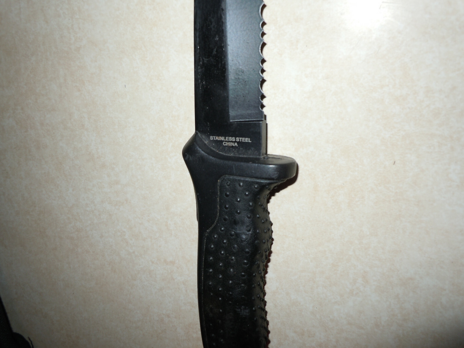 Serrated Knife in original Sheathe. Black in color.  Stainless Steel.