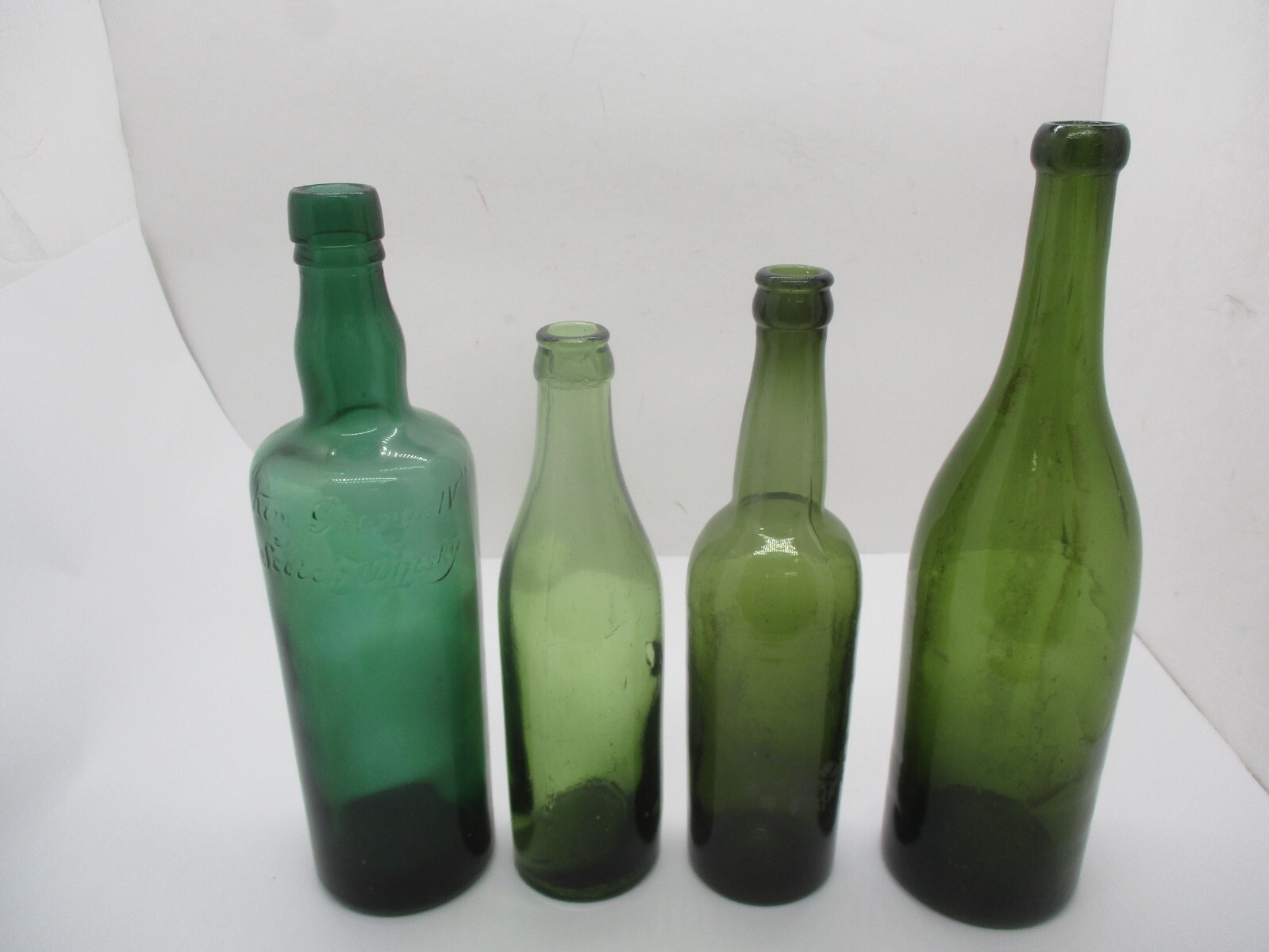 4 Green Glass Liquor Bottles .. King George Scotch Whiskey, Etc