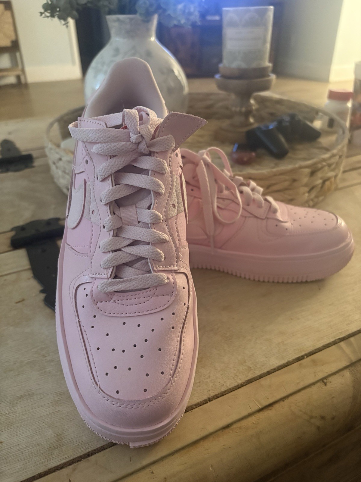 Size 9.5 All-over pink Nike low-top sneakers. Smooth leather-like upper