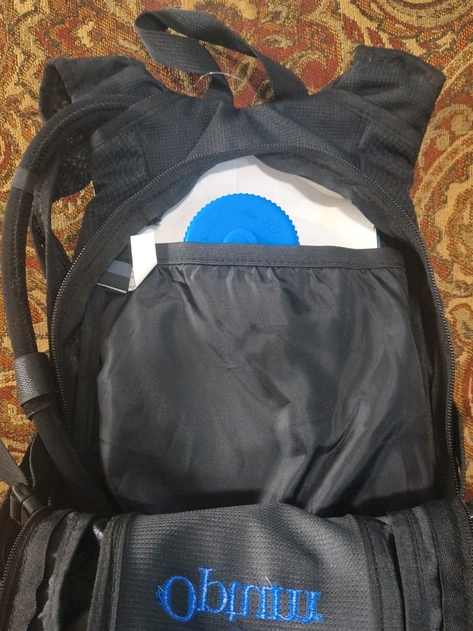 High Sierra lightweight hiking hydration pack customized with a blue Optum Logo
