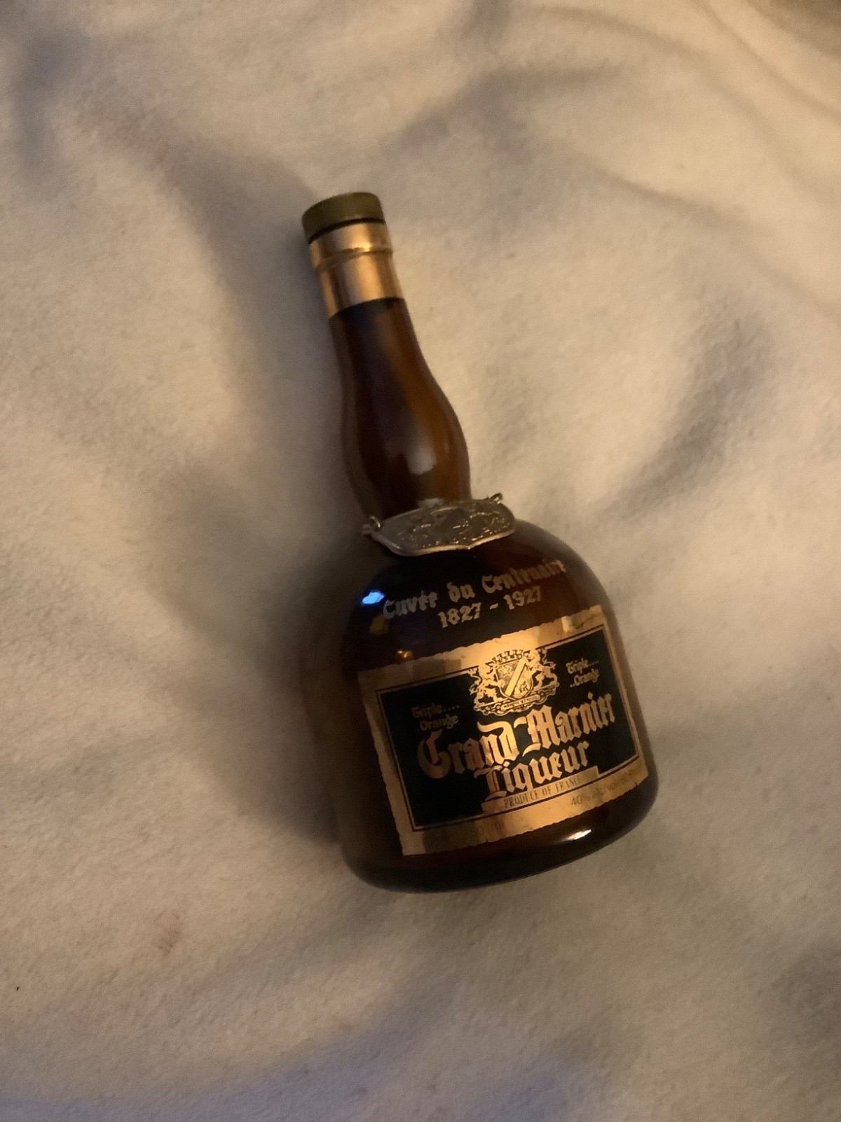 Empty bottle of 100-year old Grand Marnier with original cork and medallion