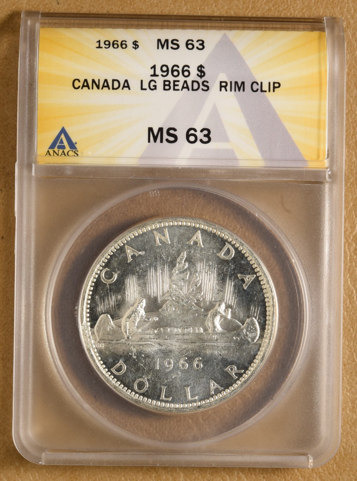 1966 Canada Silver Dollar with Large Beads & Rim Clip ANACS MS63