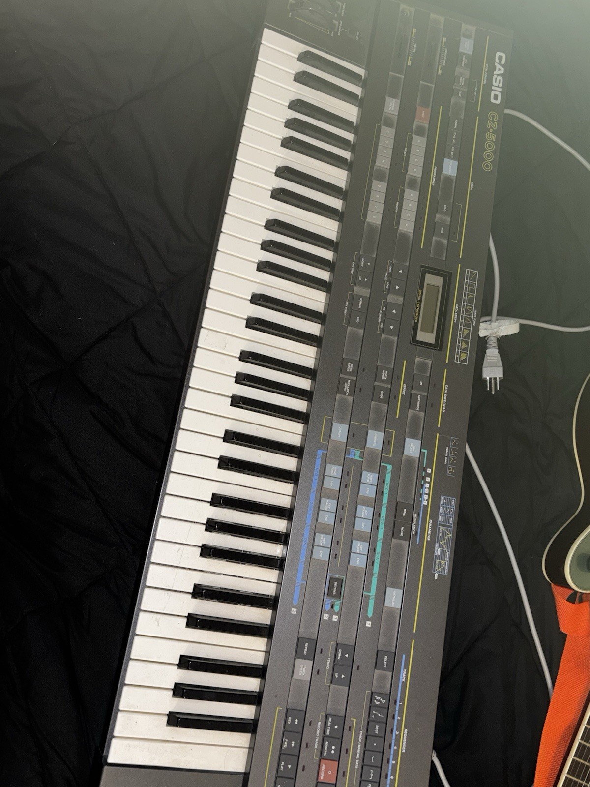 Casio CZ-5000 comes with power cable and stand