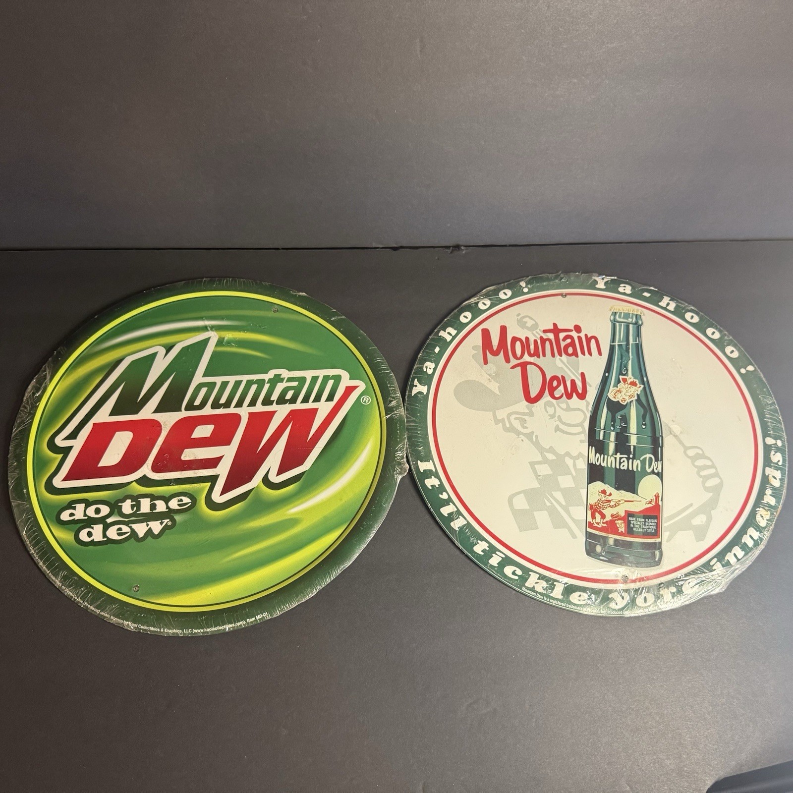 2 Round Tin Mountain Dew Signs