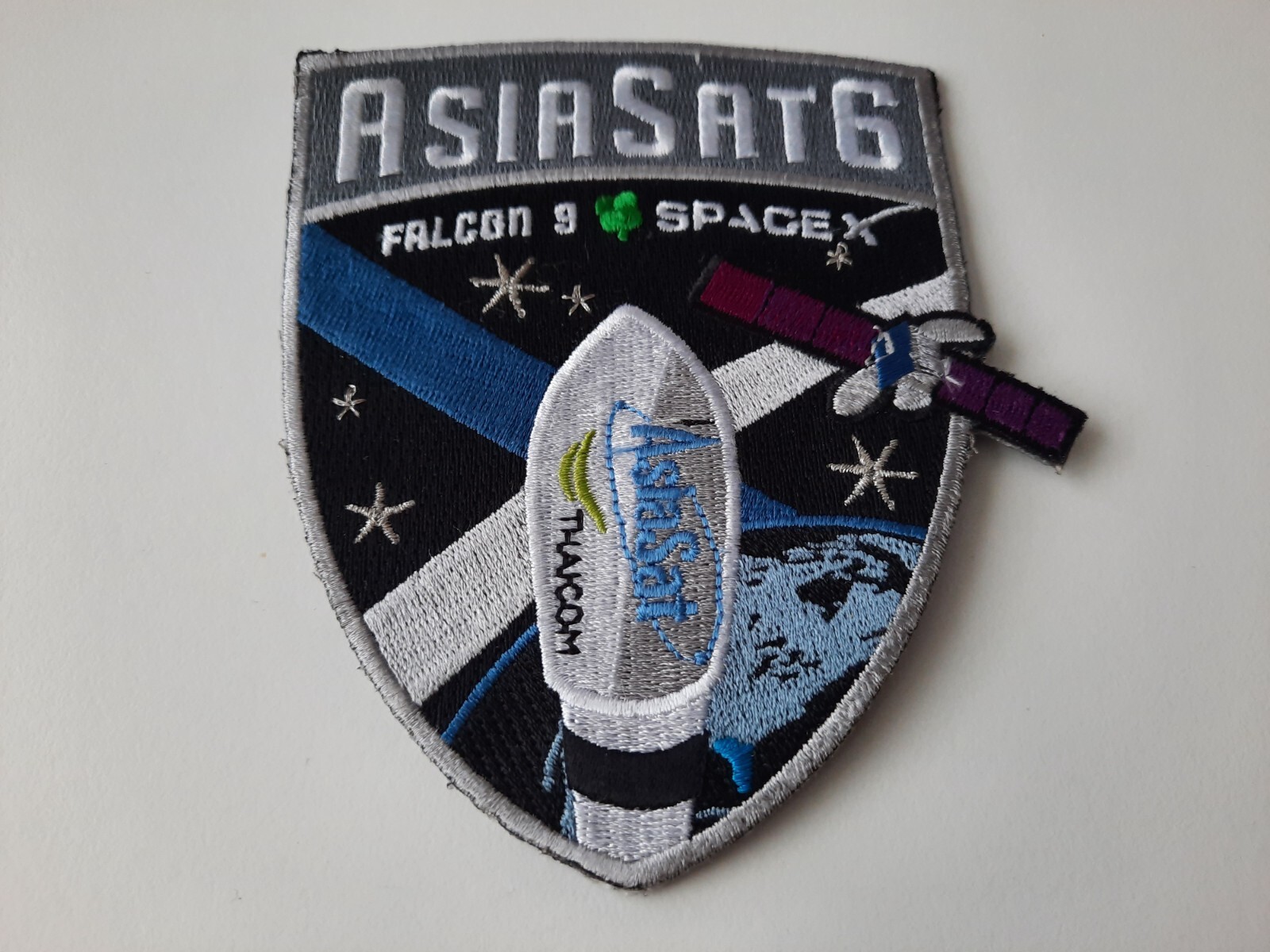 SpaceX Falcon-9 rocket launch with AsiaSat-6 satellite patch