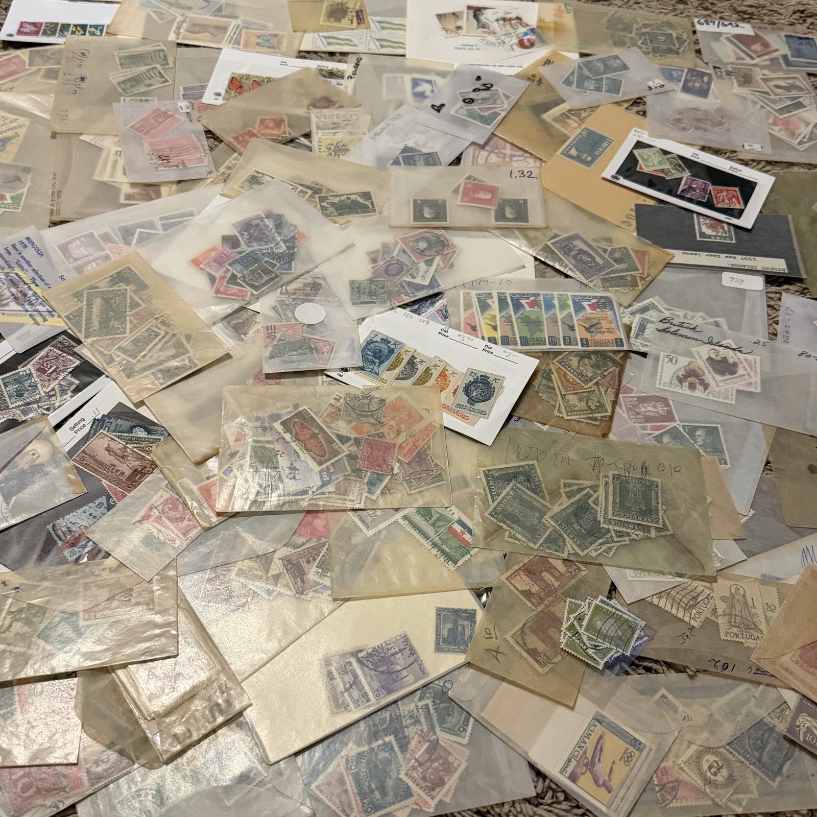 MASSIVE LOT OF WORLDWIDE STAMPS IN GLASSINES FRANCE CANADA GERMANY UK AND MORE