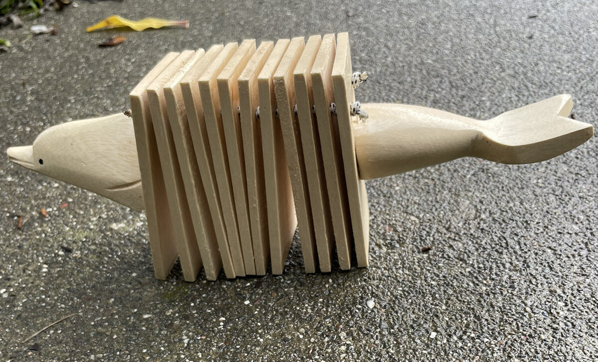 traditional dolphin music instrument Shaped Clacker  bali indonesia