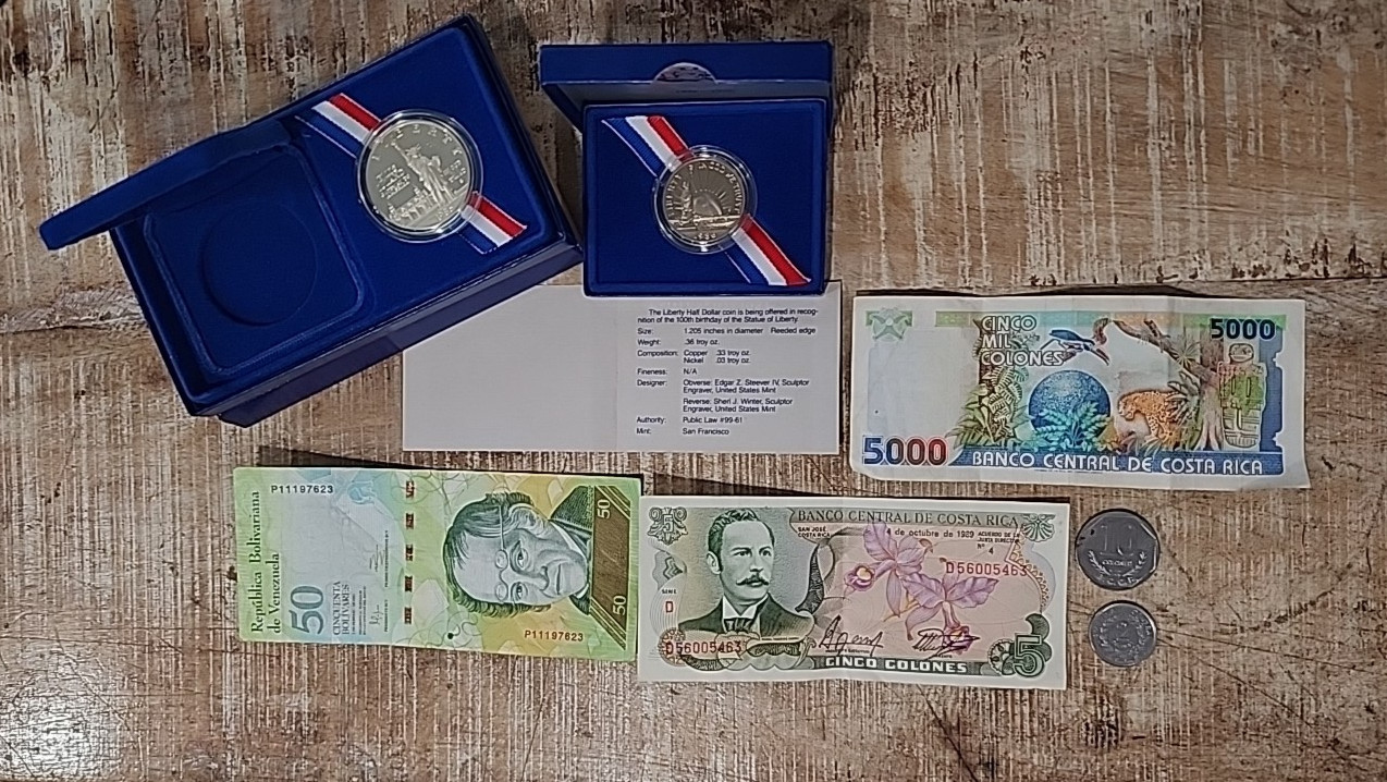 Small lot of Foreign Bank notes, coins, US Liberty Half Dollar, and Ellis Island