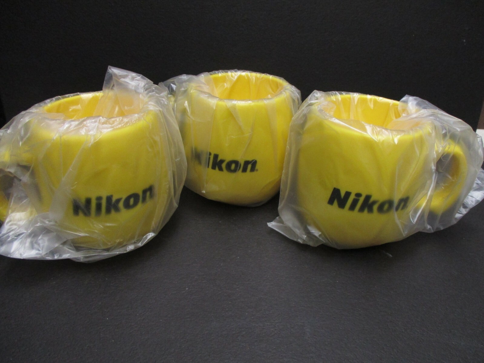 Nikon 10 ounce Yellow plastic drinking mug nikon coffee cup NEW