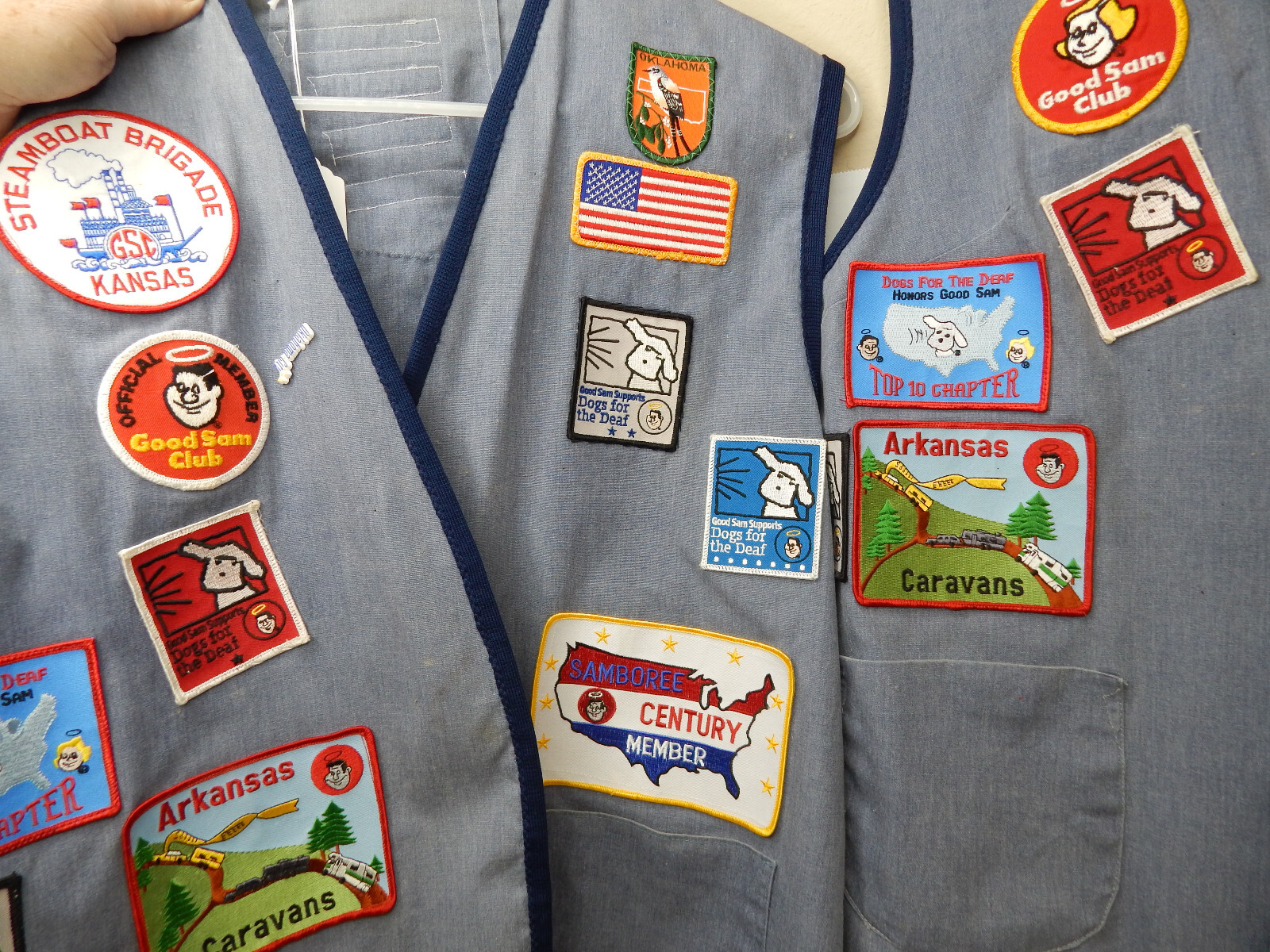 A beautiful lot of 2 Good Sams Club vests with bunches of patches plus vest clip