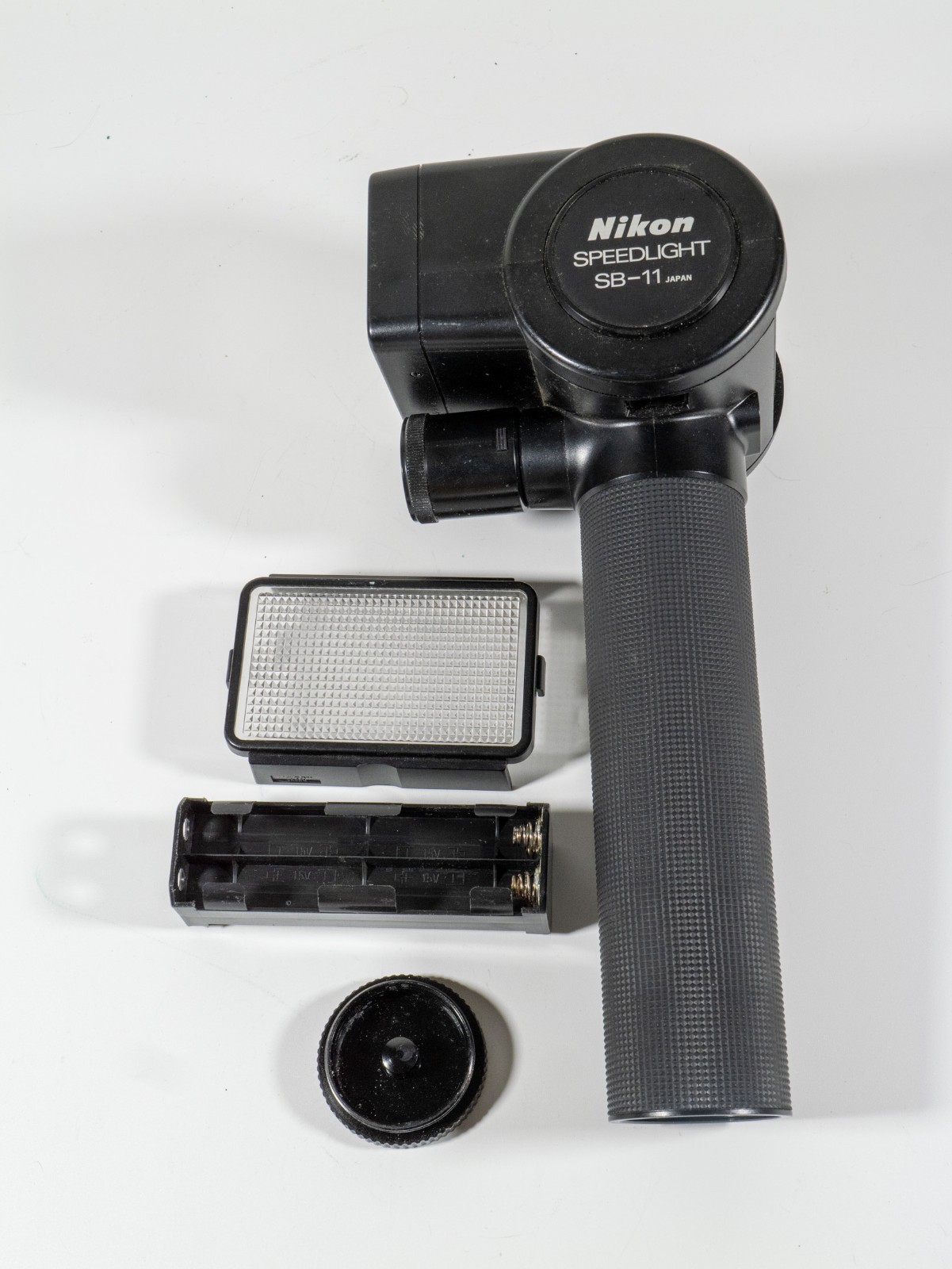 Nikon SB-11 Flash (non-working) with diffuser, battery holder, sensor, and cap.