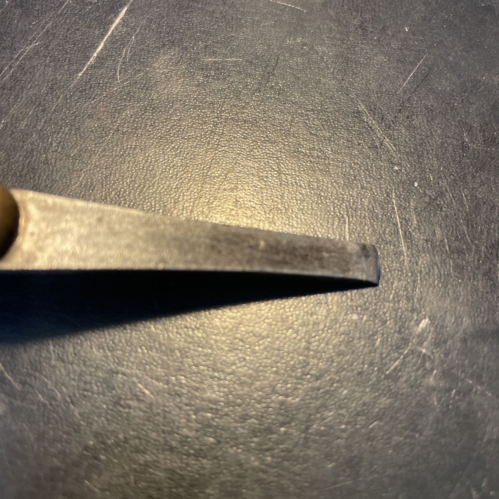 Wood handled screwdriver style tool with brass sparrow