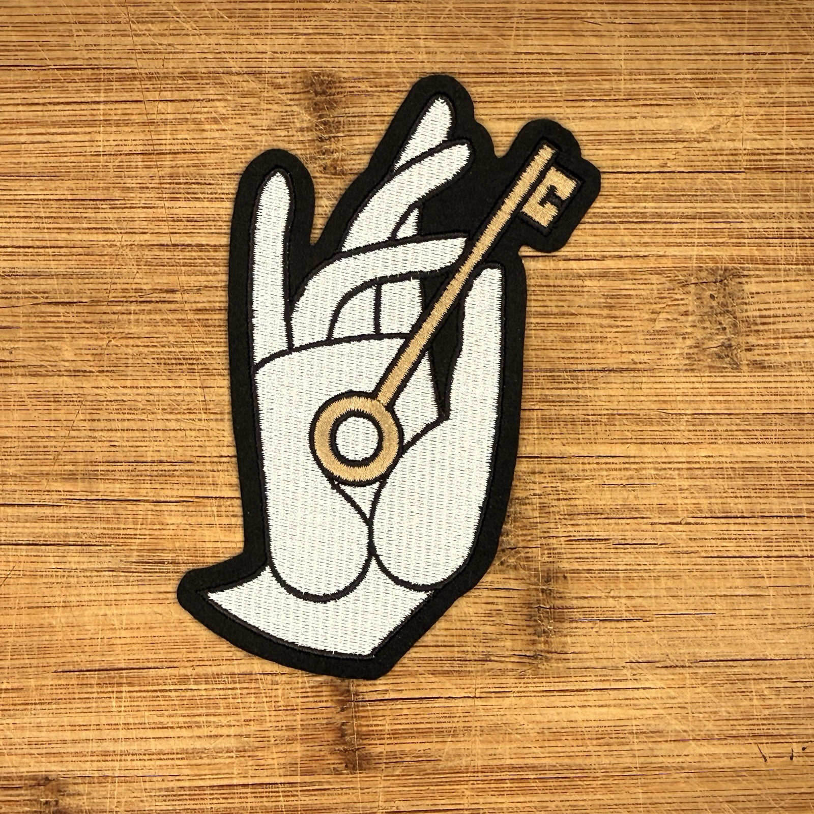 Hand Holding Skeleton Key Novelty Embroidered Patch 5x3in