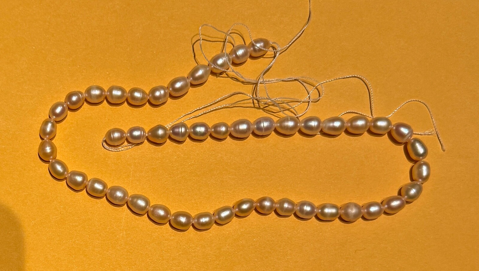 A full string of fresh water pearl, oval, peach , 7-8 mm
