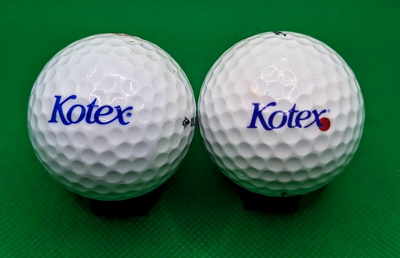 2 Different Kotex Brand logo golf balls - Feminine Hygiene Products