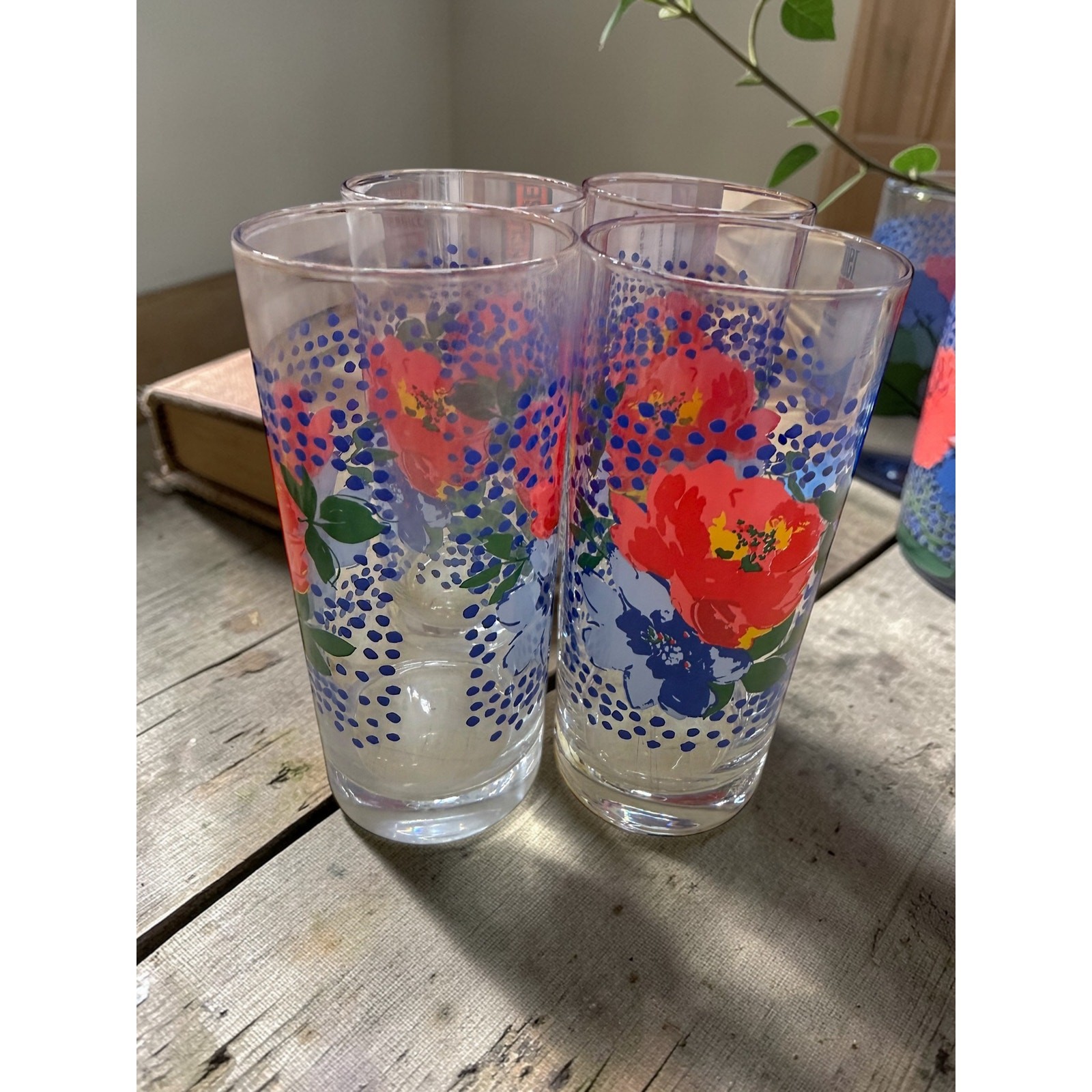 Collectible set of four Pioneer Woman Melody floral pattern glass tumblers.
