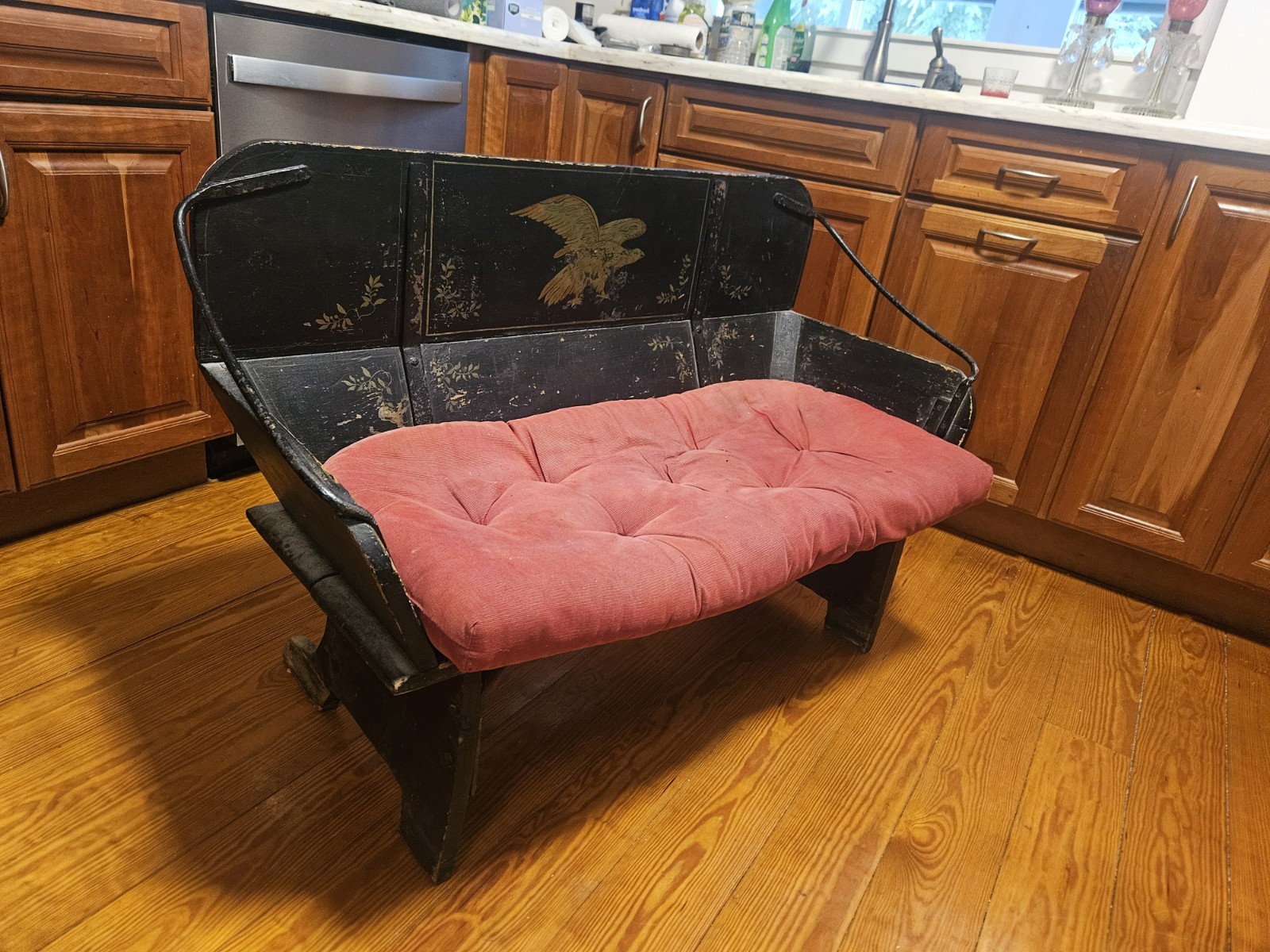Antique Black Wooden Bench with Red Upholstered Cushion, Eagle Motif, 48" Wide