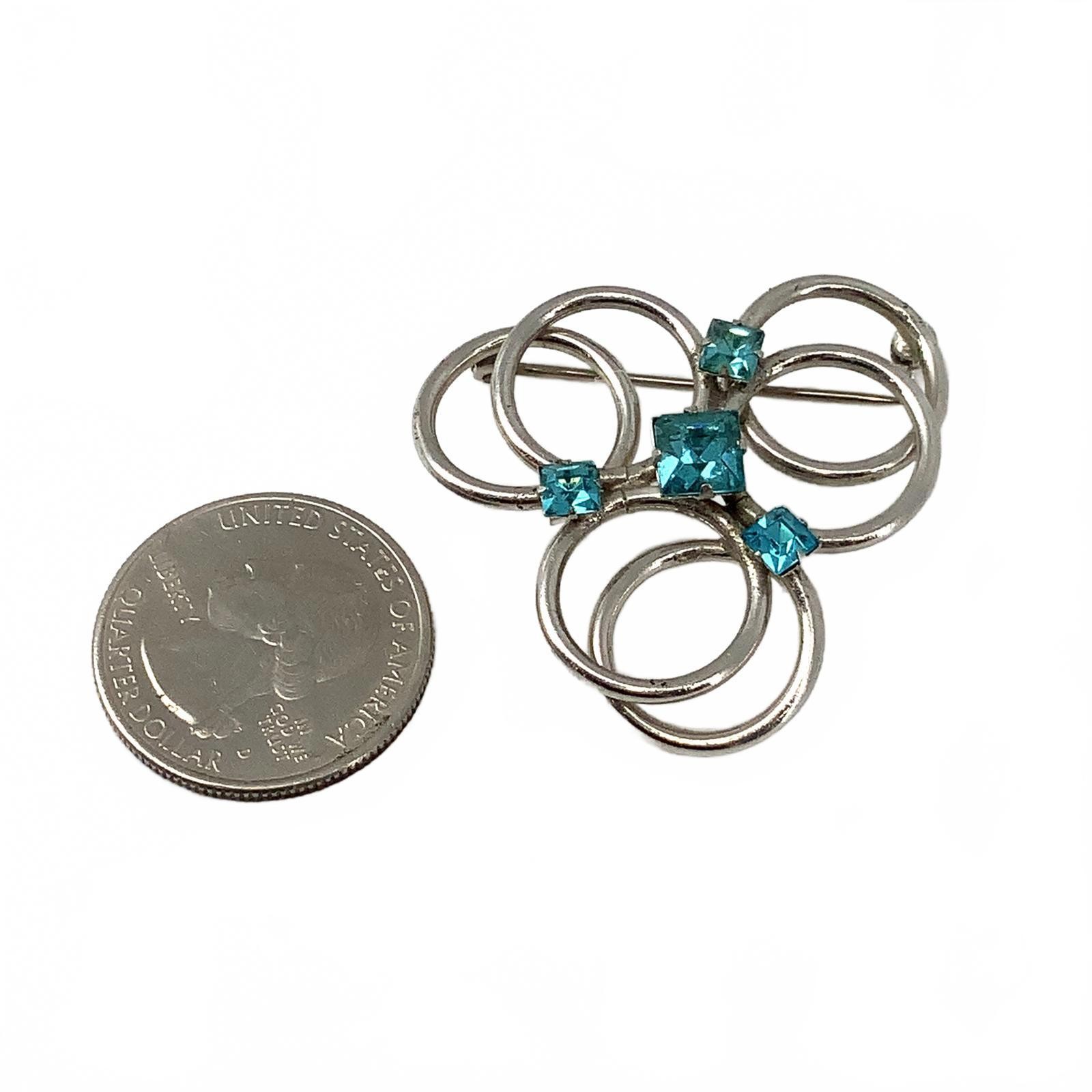Vintage Silvertone Blue Crystal Mid Century Brooch Interlocking Circle Pin