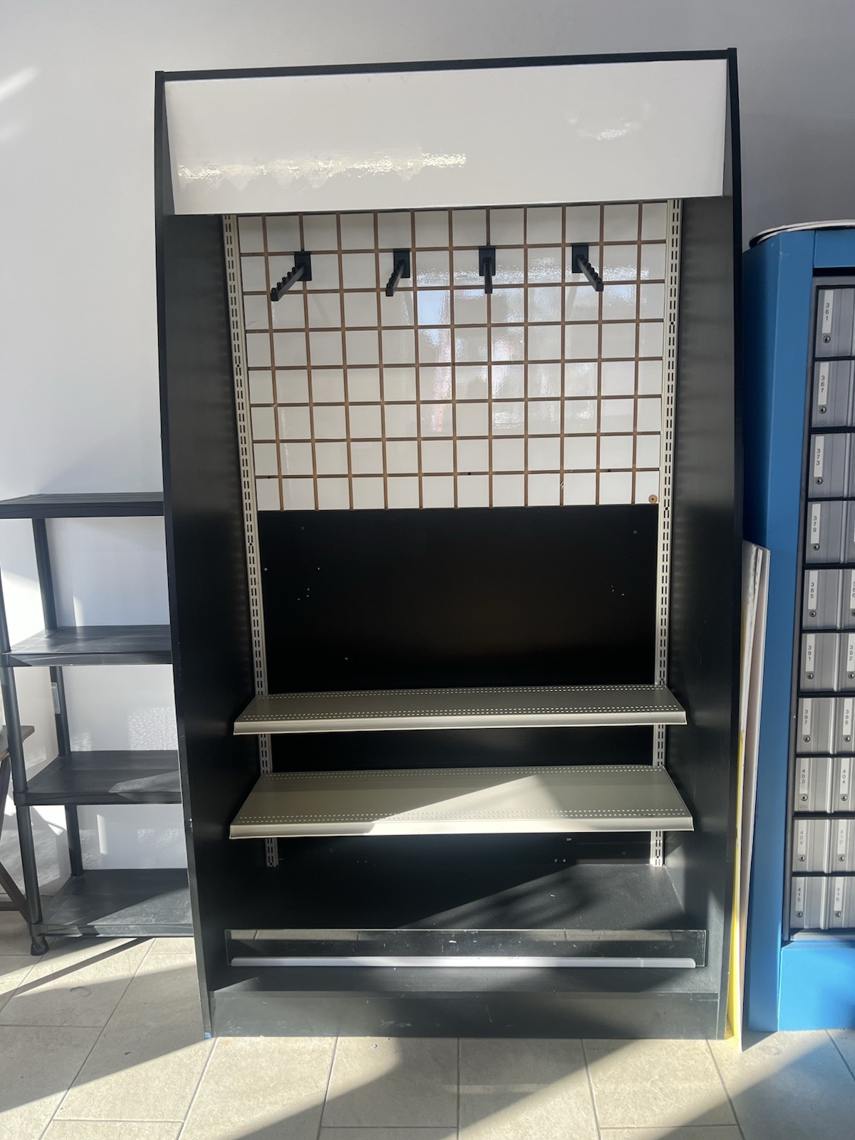 Black Metal Warehouse Shelving Unit with Shelves and Grid Back
