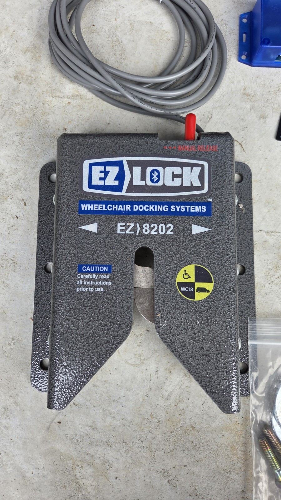EZ Lock wheelchair lock down device like Qstraint QLock