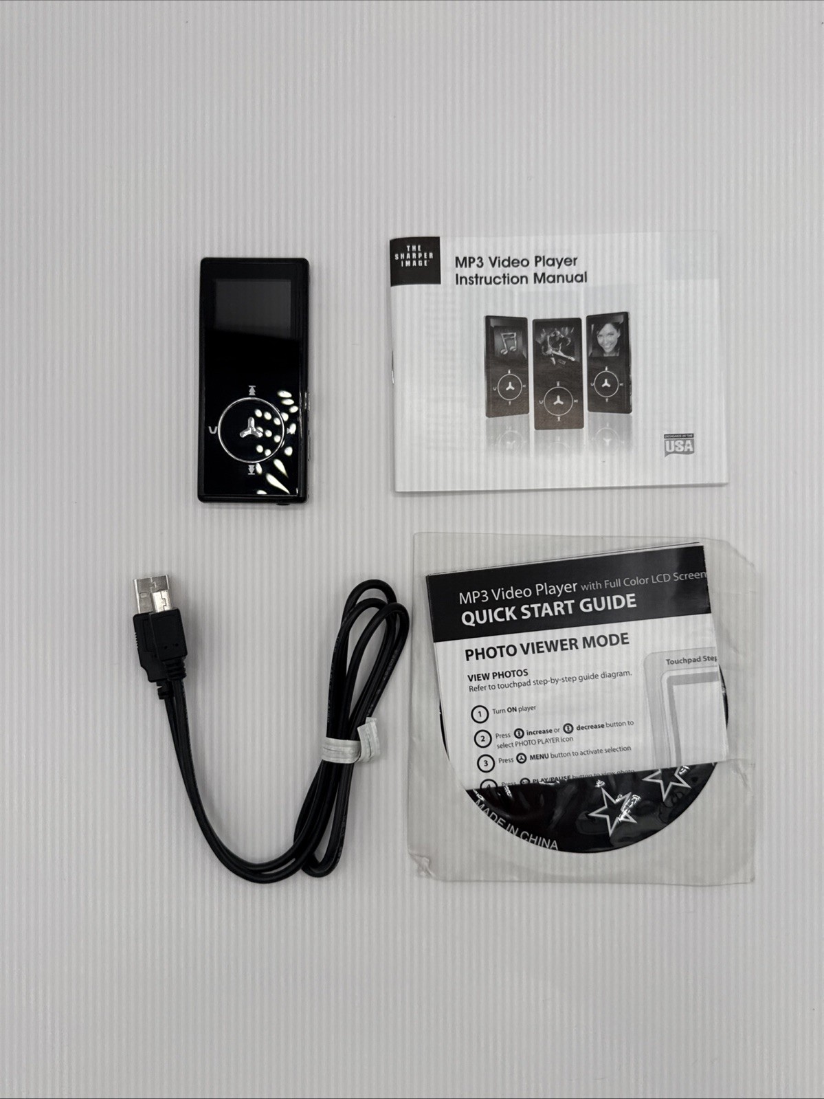 MP3 Player - The Sharper Image- User Guide And Accessories  Some Scratches
