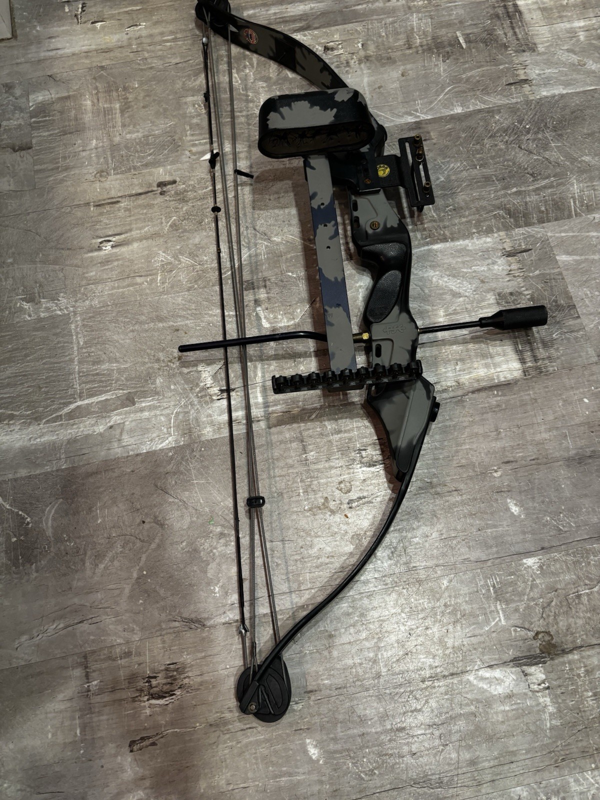 This item is a PSE Polaris Express bow riser, featuring a camouflage design.