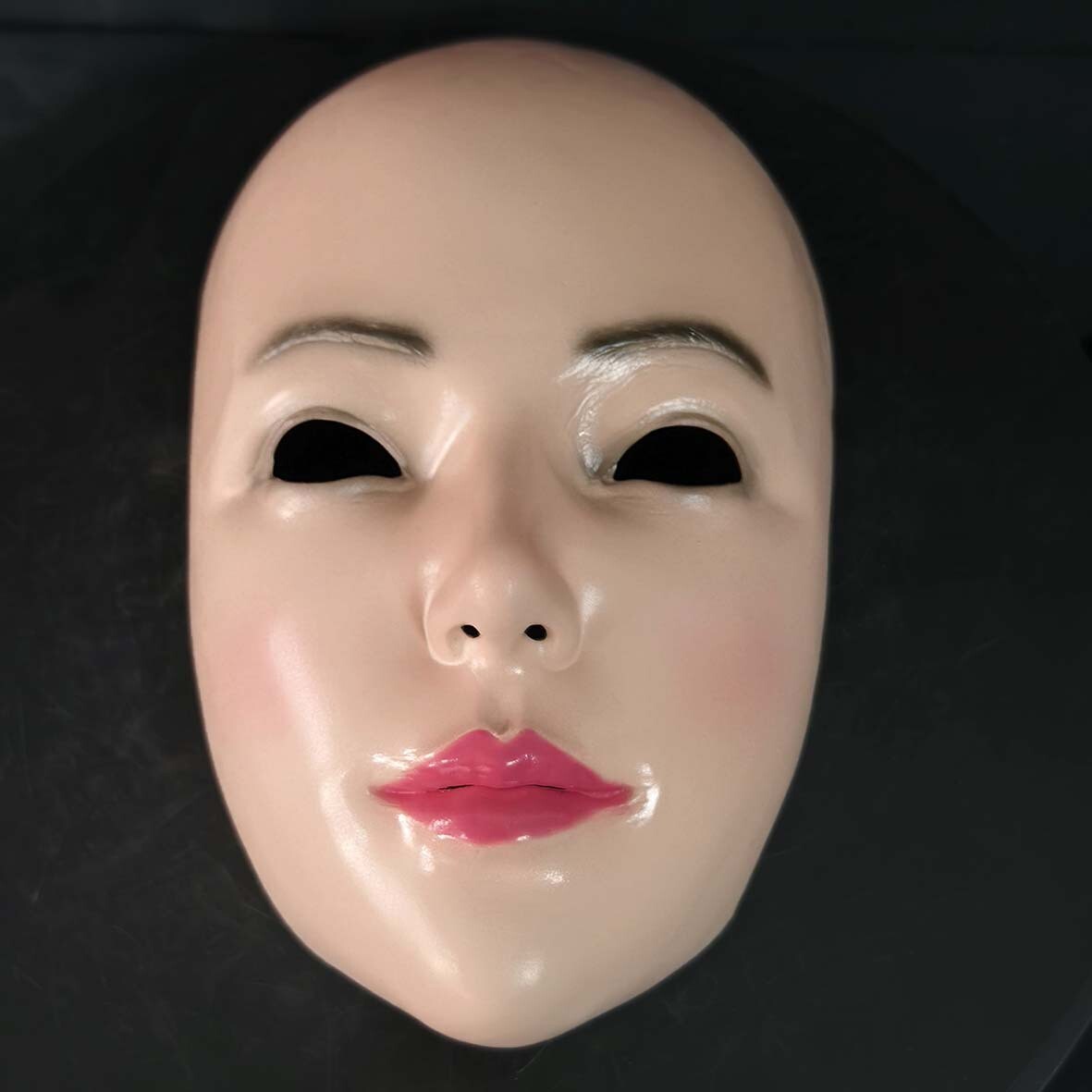 Half face of beautiful woman latex mask