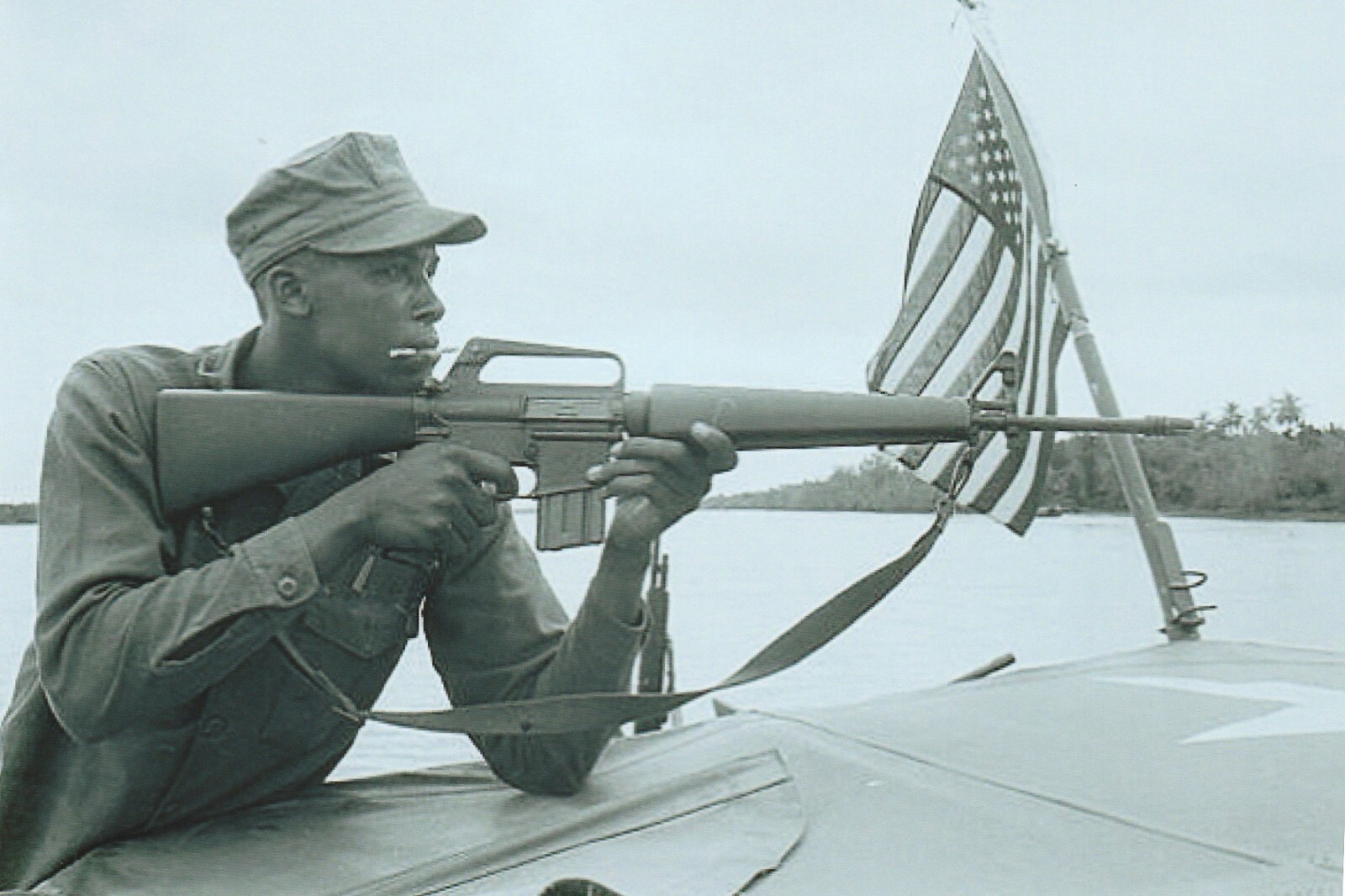 Vietnam  War  Photo --  Soldier With Rifle On Patrol Boat