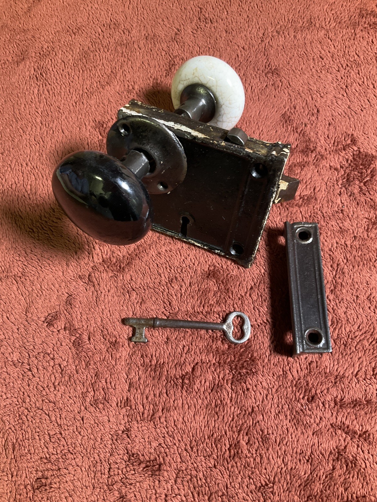 Antique Steel Rim Door Lockset, 1 Keeper, 1 Ring, 2 Porcelain Knobs, 1 Key