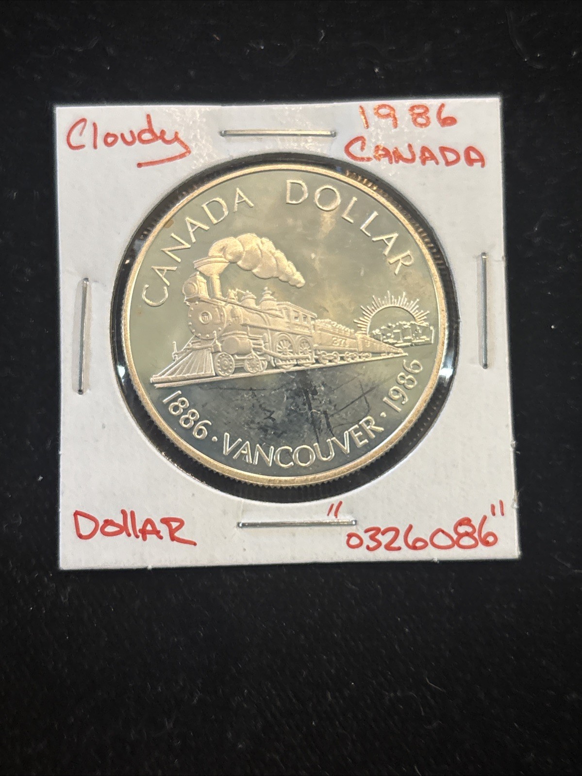 1986 Canada Silver Dollar Vancouver Train Proof “0326086” Canadian $1 Cloudy