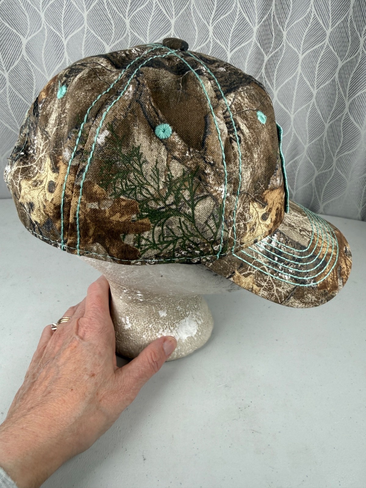 Real Tree Gold Sparkle Logo Black Aqua Rivet Patch on Camouflage Hat Cap