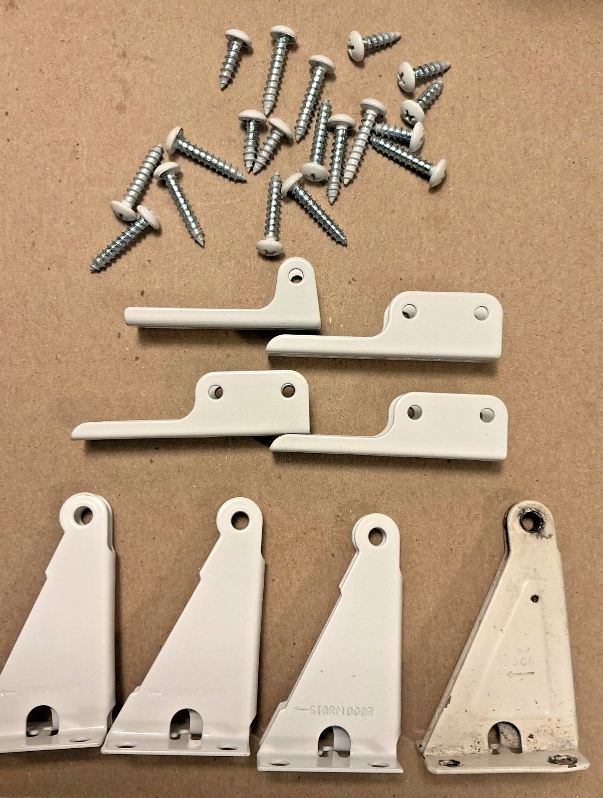 Storm Door White Brackets and Screws (one used see photos) 1 5/8” high 2.75” lon