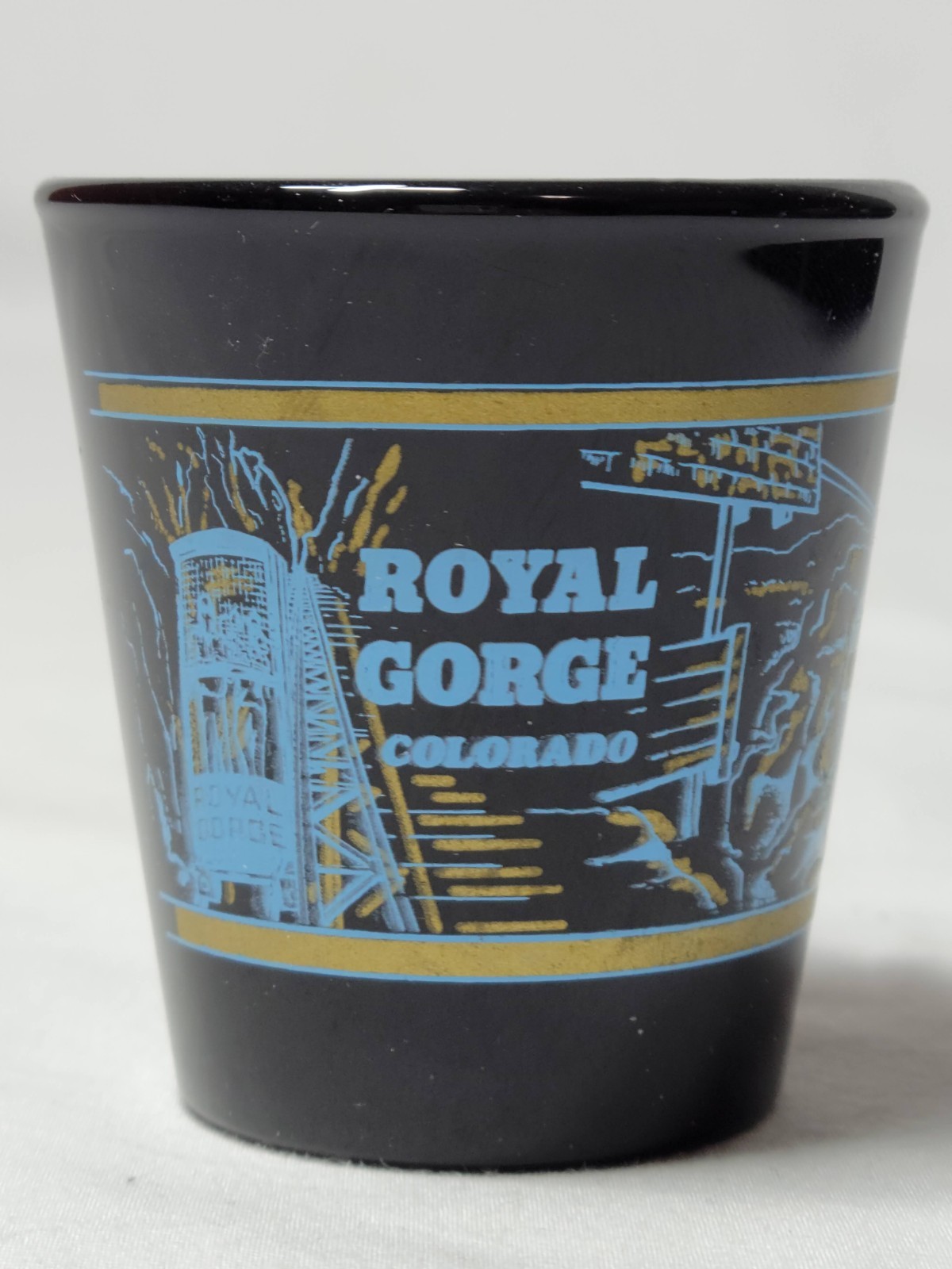 Royal Gorge Colorado Black Souvenir Shot Glass with Blue and Gold Accent Artwork
