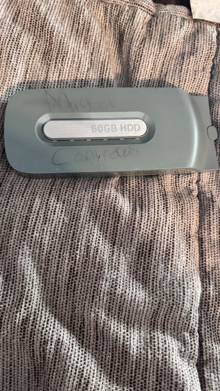 Microsoft Xbox 360 hard drive 60gb with some writing on the shell