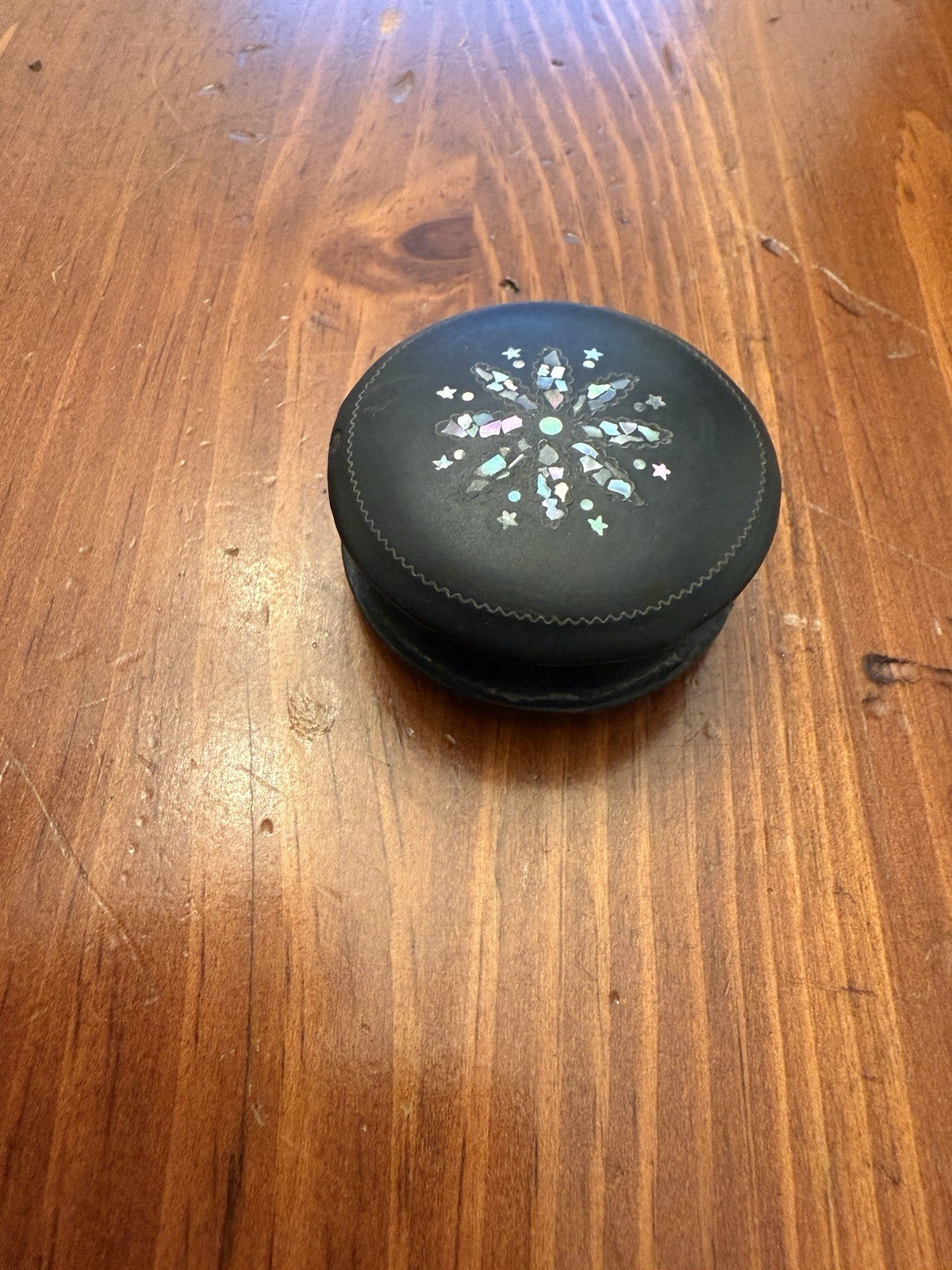 A modern decorative round case with iridescent inlay.