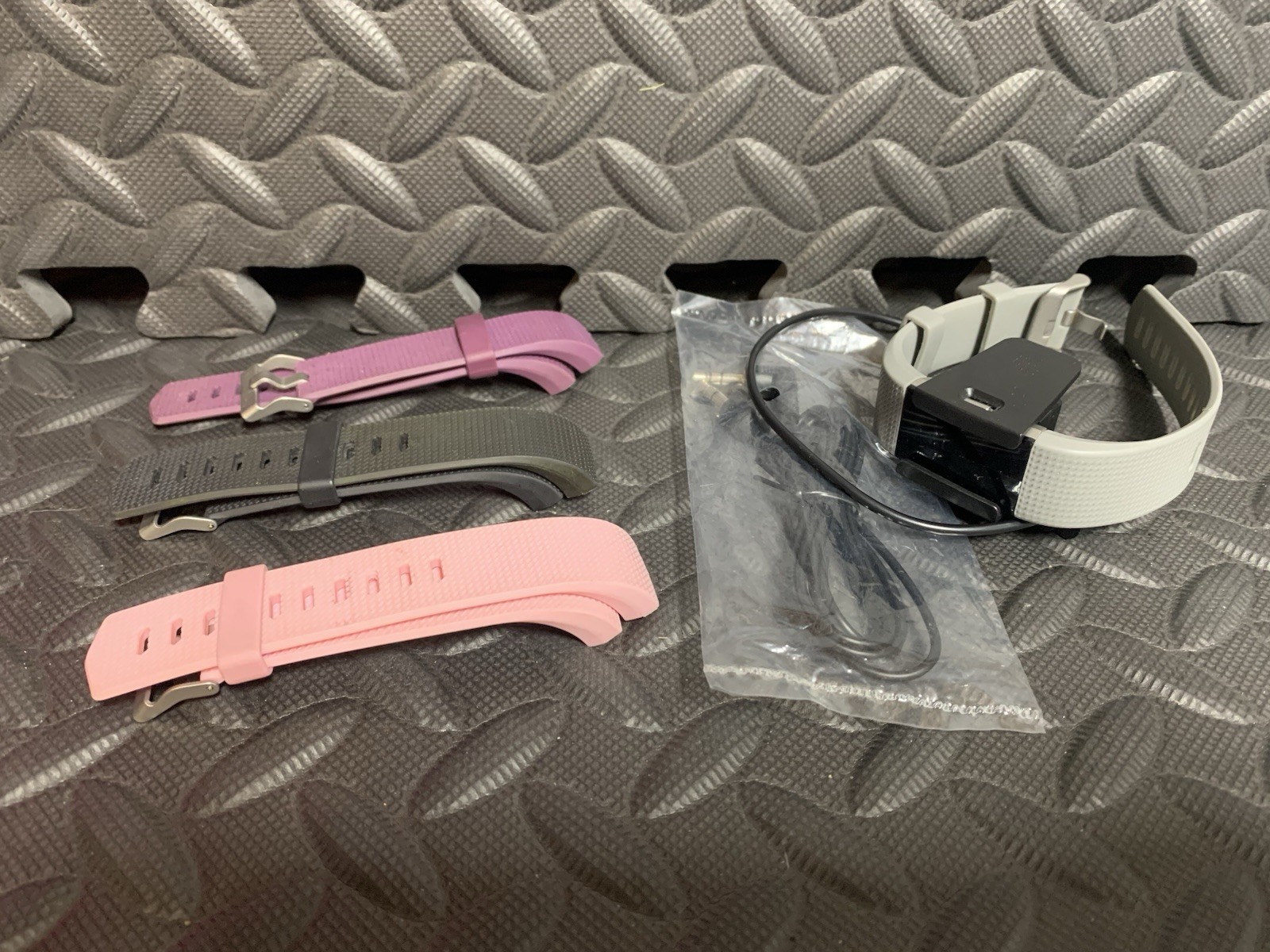 Fit Bit ~ 4 Bands (Pink, Purple, Black, & Gray) ~ Charger ~ Screen Is Cracked