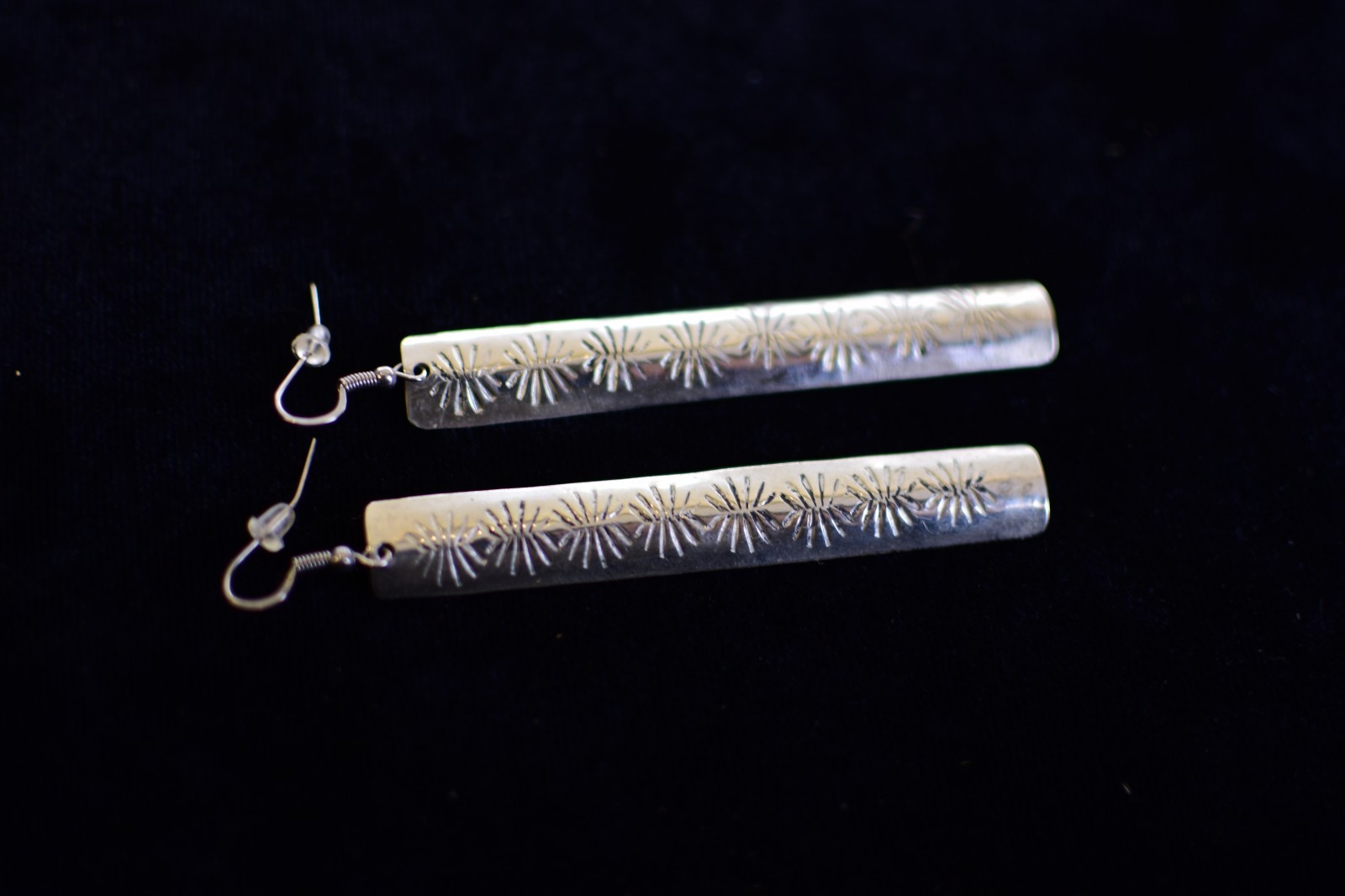 silver-toned metal drop earrings with stamped sunburst designs