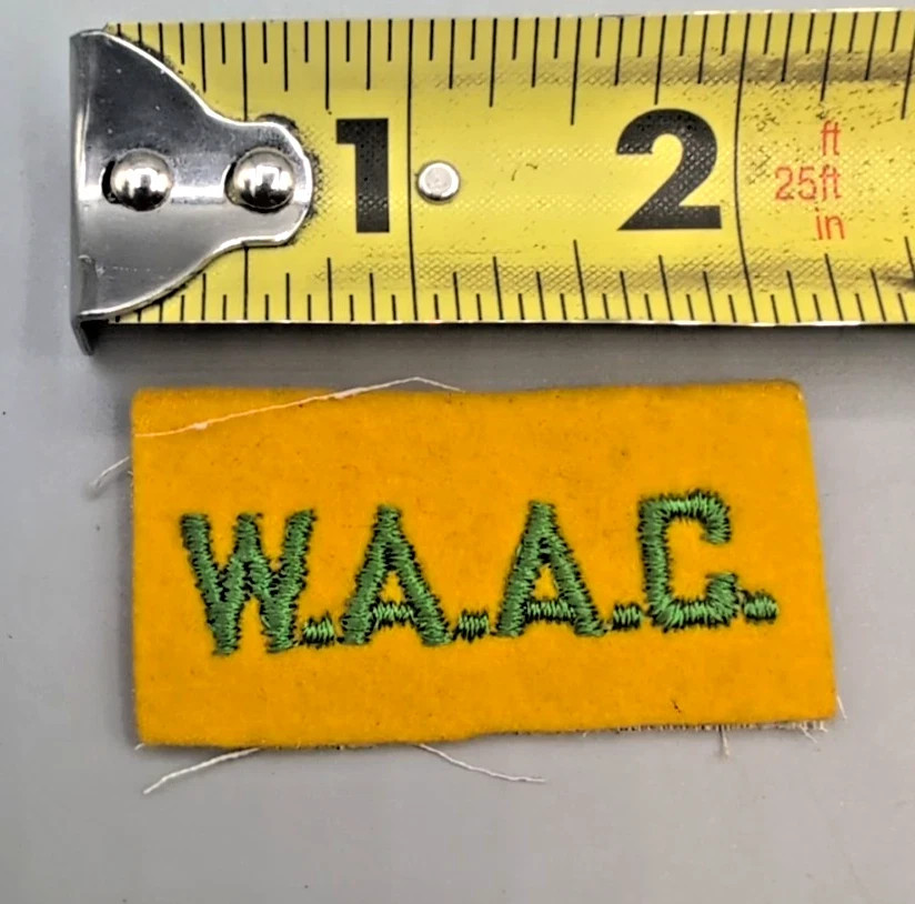 WWII/2 US Army WAAC green on yellow cheesecloth backed tab.