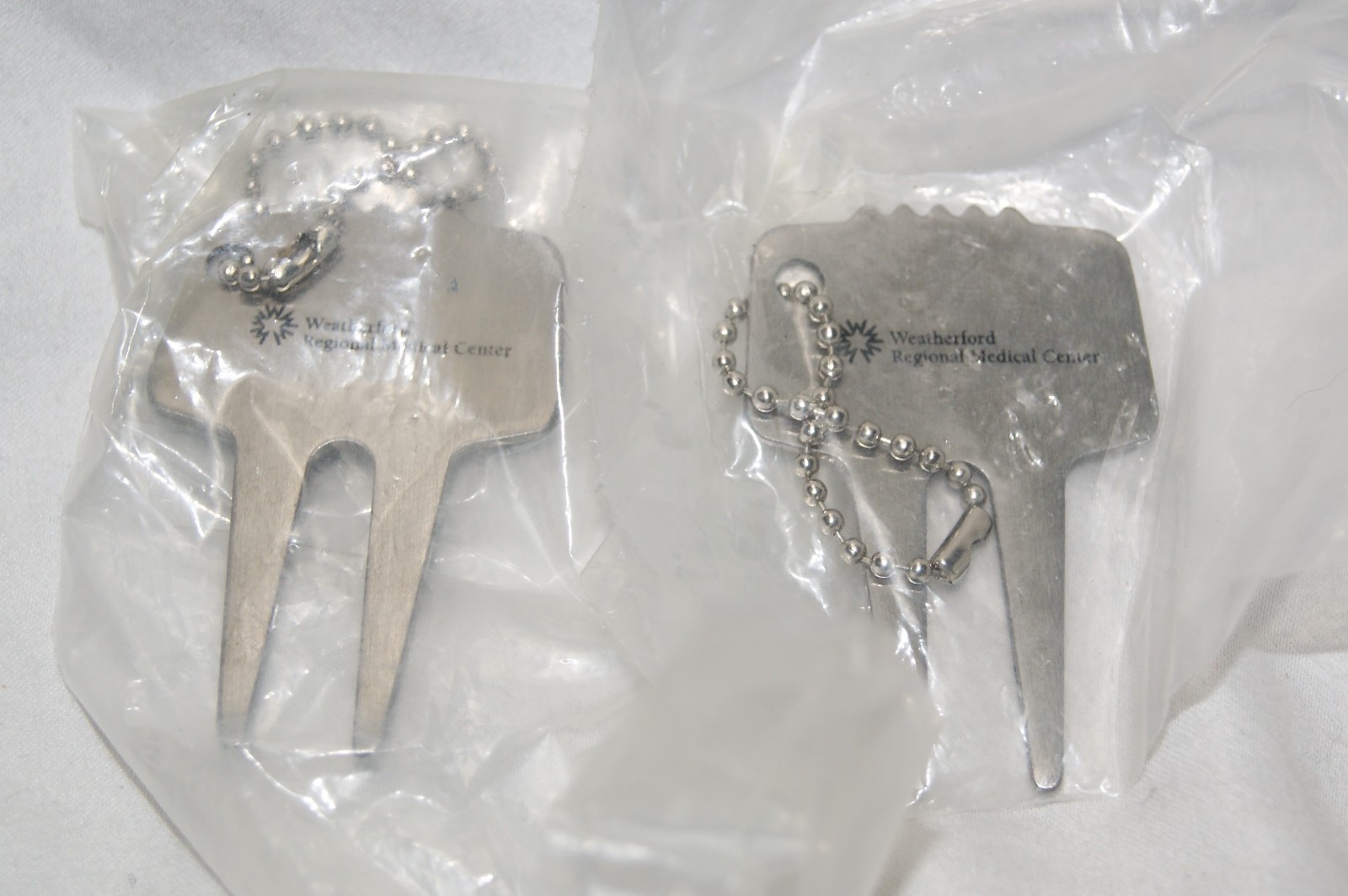 pair of weatherford texas regional medical center golf divot repair tool
