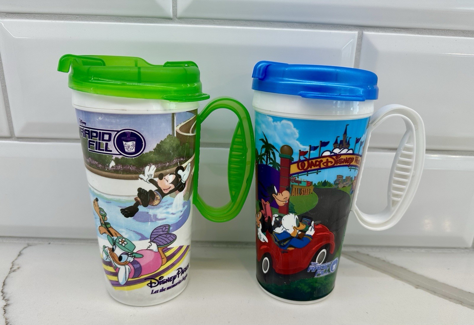 SET OF 2 Disney Parks Rapid Fill 16 oz Souvenir Travel Mug W/Lid Mickey Donald
