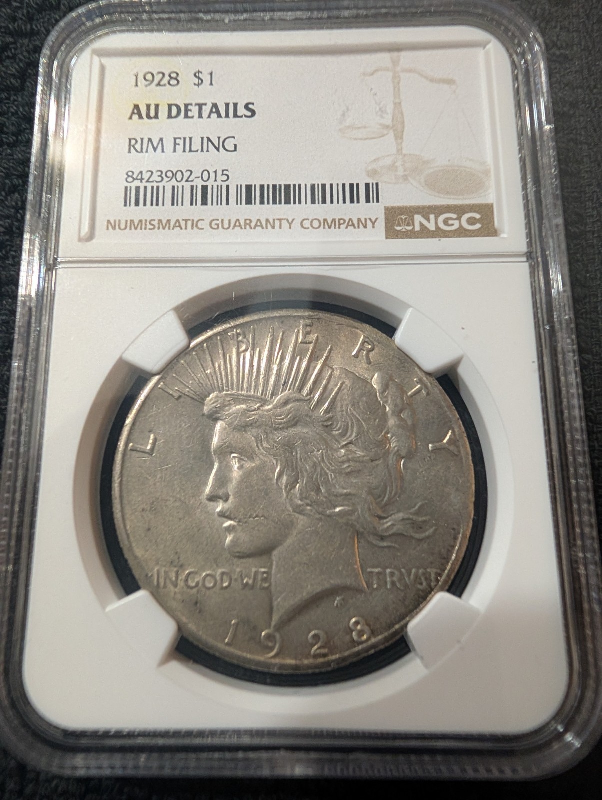 1928 Peace Dollar $1 Silver 0.9 Business Strike Philadelphia NGC AU Rim Filing