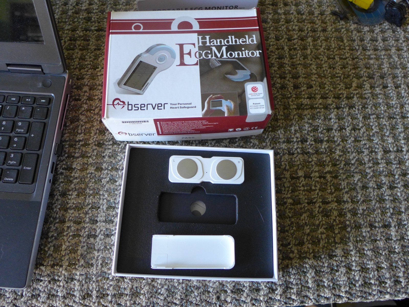 2 HANDHELD EKG MONITORS. ONE WITH SCREEN, ONE USES A PHONE APP.