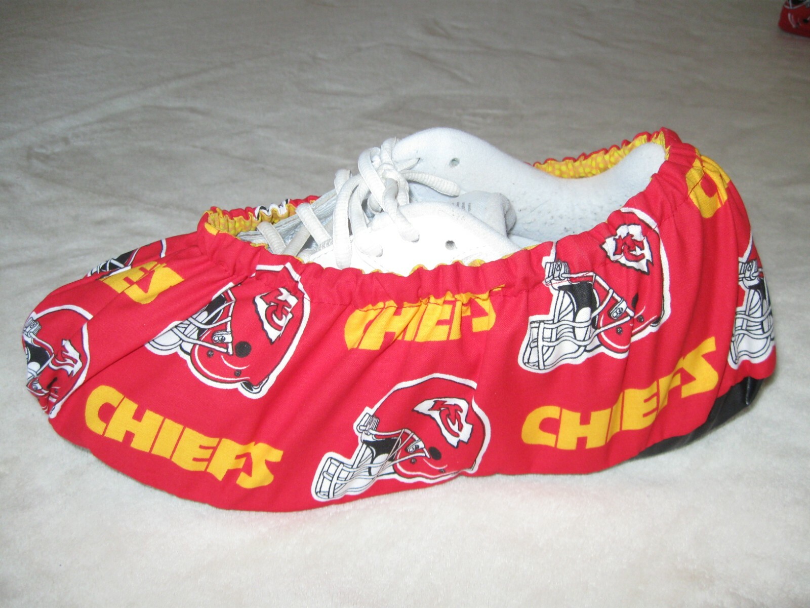 K.C. Chiefs bowling shoe covers. Men's size 10-12. Cotton, lined, vinyl soles.