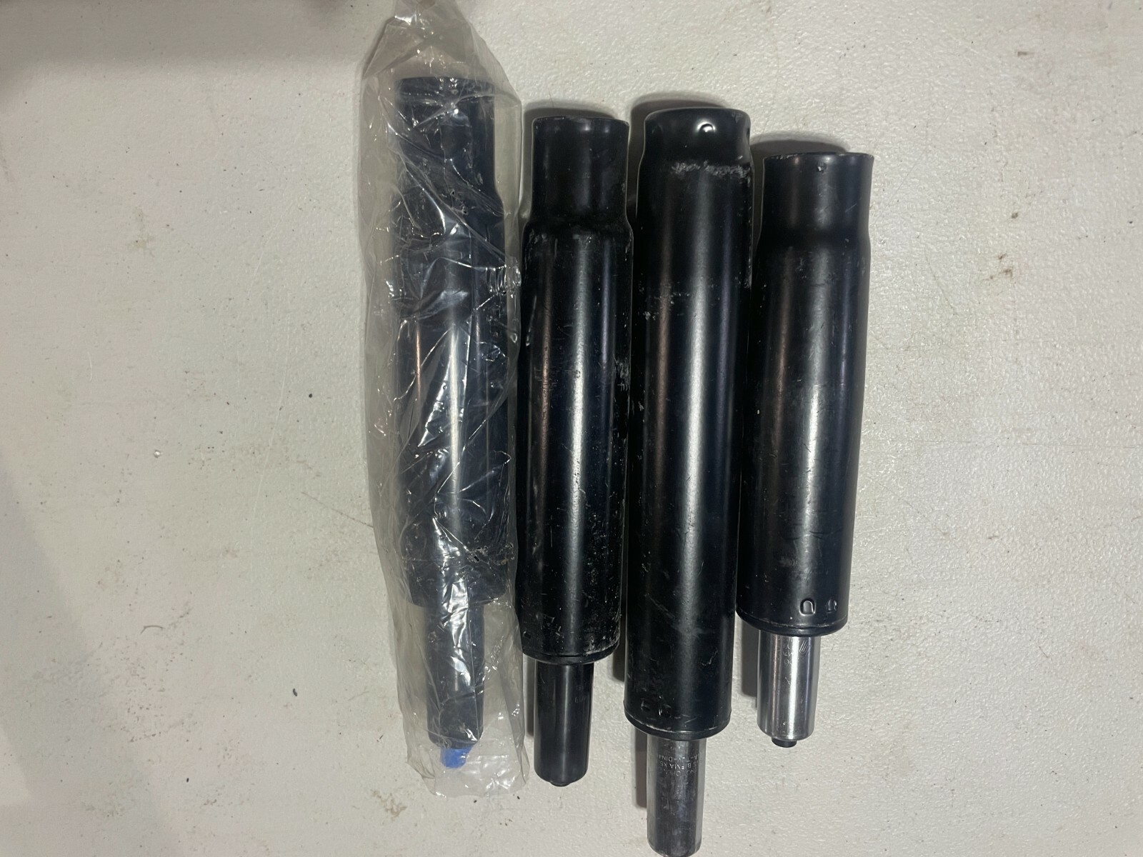 lot of 4 various BIFMA and other Chair Gas Lift Cylinder