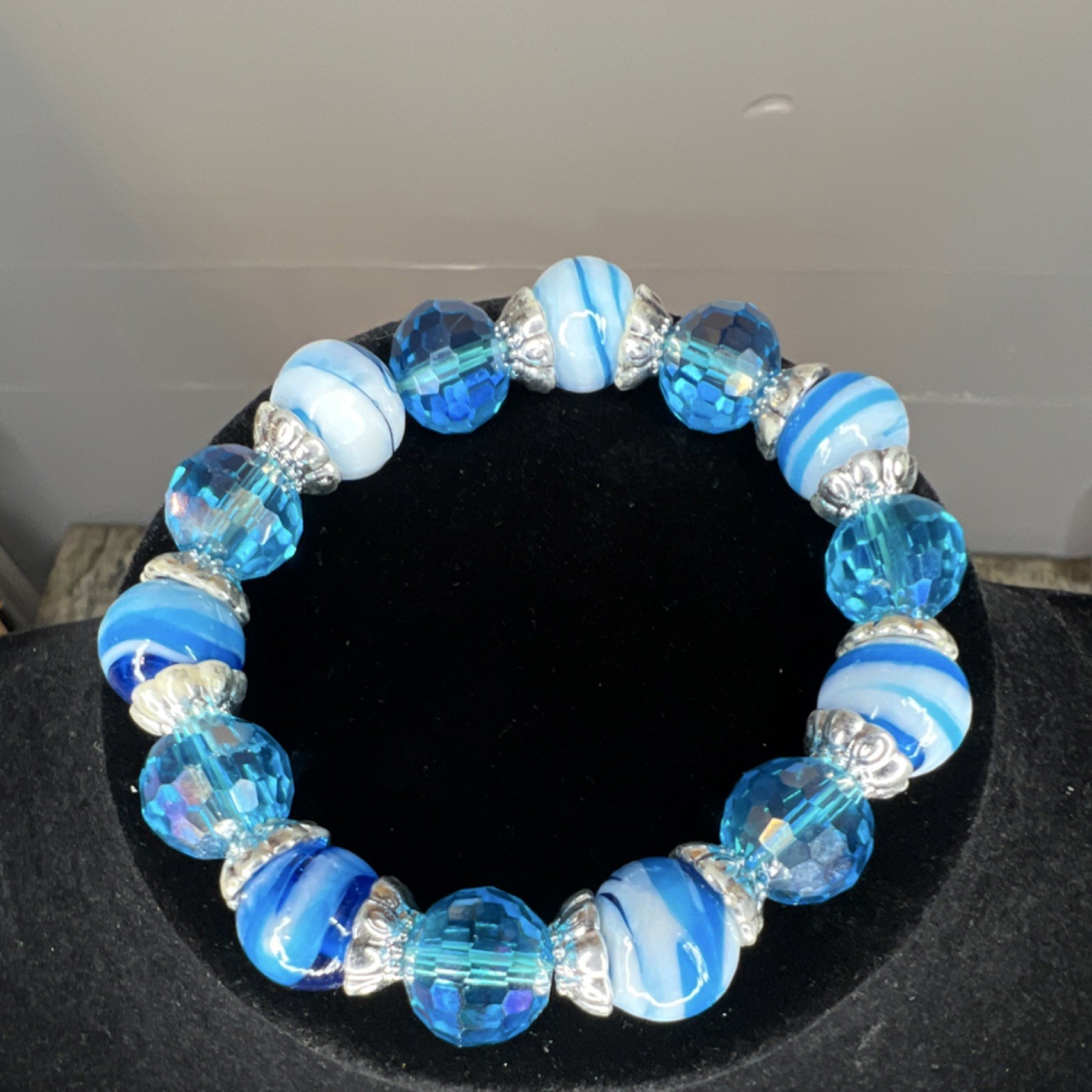 Beaded blue and white glass bracelet, silver tone spacers, adjustable