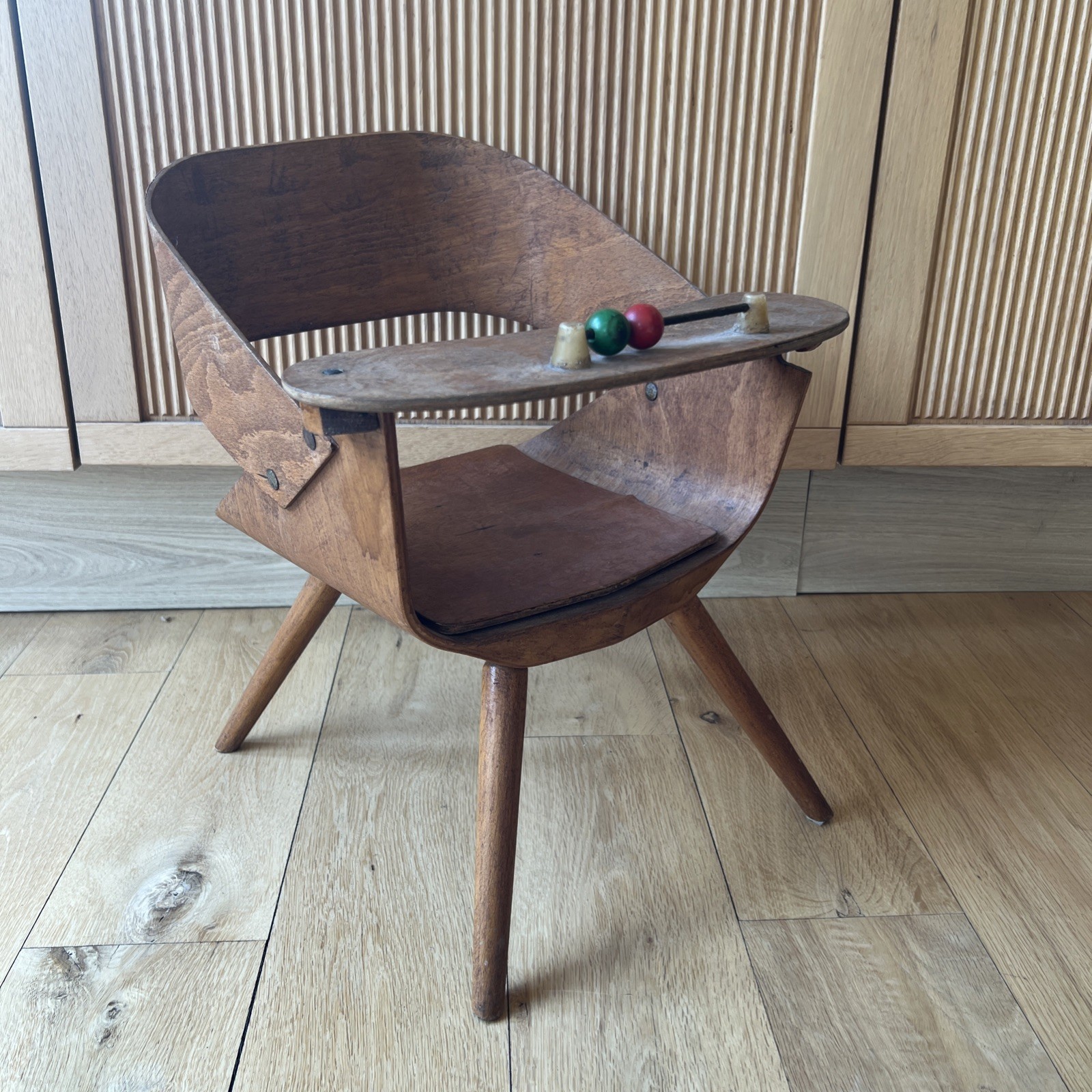 Eames style formed ply bent wooden childs nursery chair with potty cover