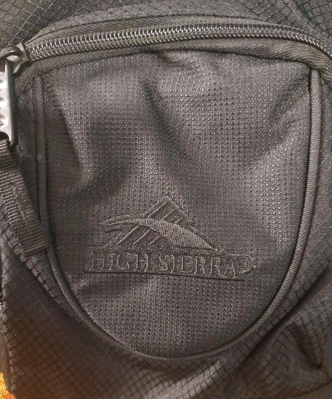 High Sierra lightweight hiking hydration pack customized with a blue Optum Logo
