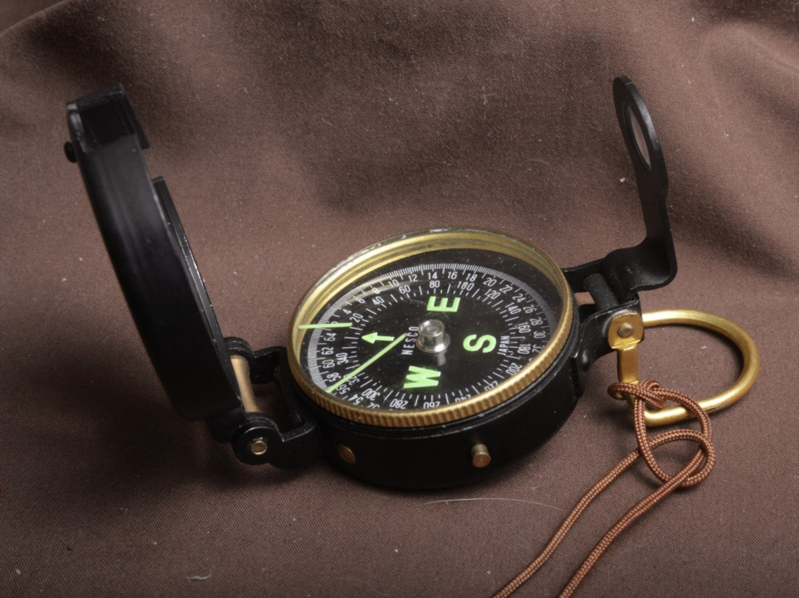 two lensatic compasses one with box