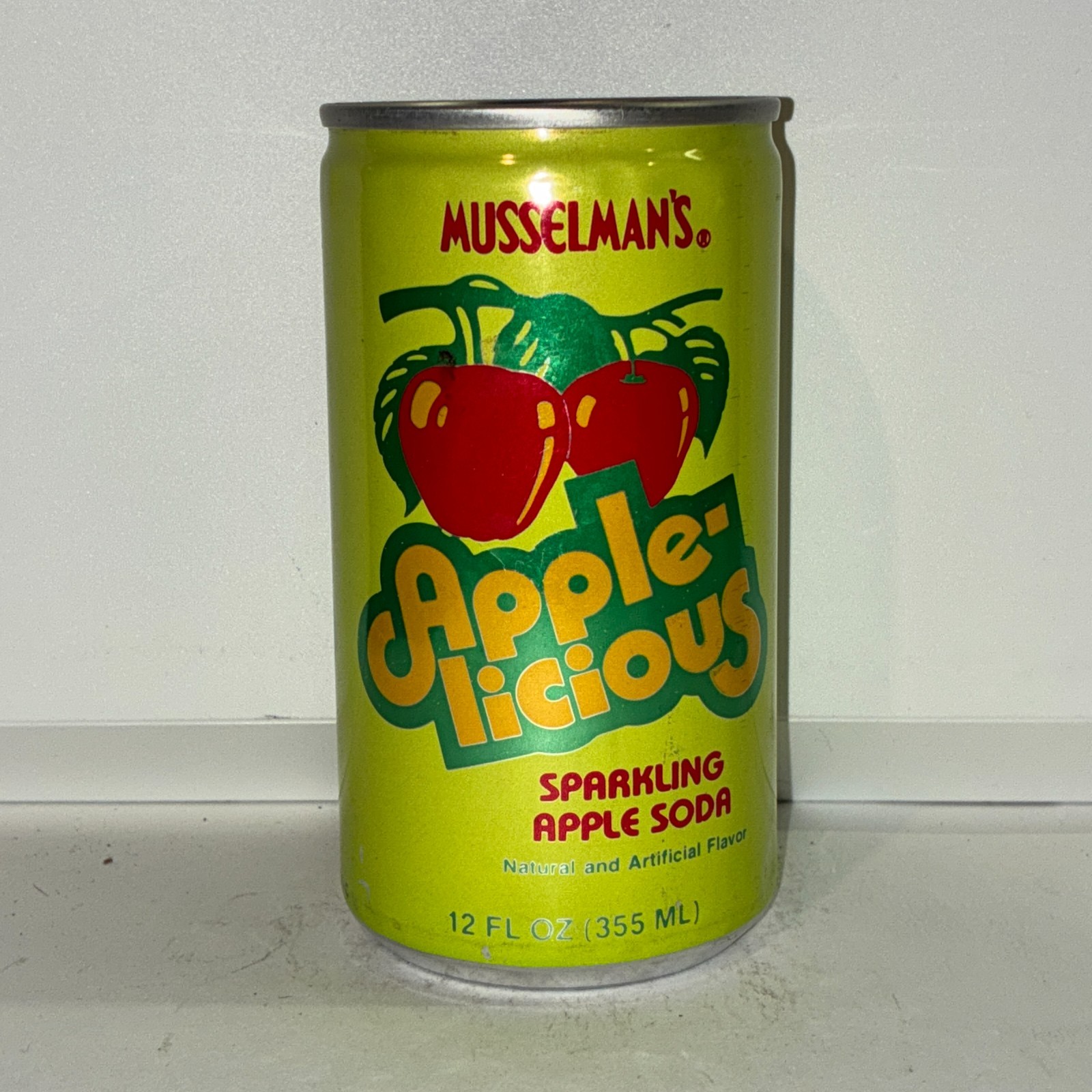 Musselman's Apple-licious Apple soda can, bottom opened